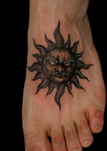 Dark Ink Old Taino Sun Tattoo On Left Foot