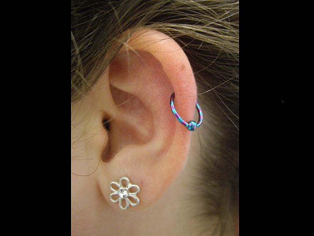 Flower Stud Lobe And Auricle Piercing Image