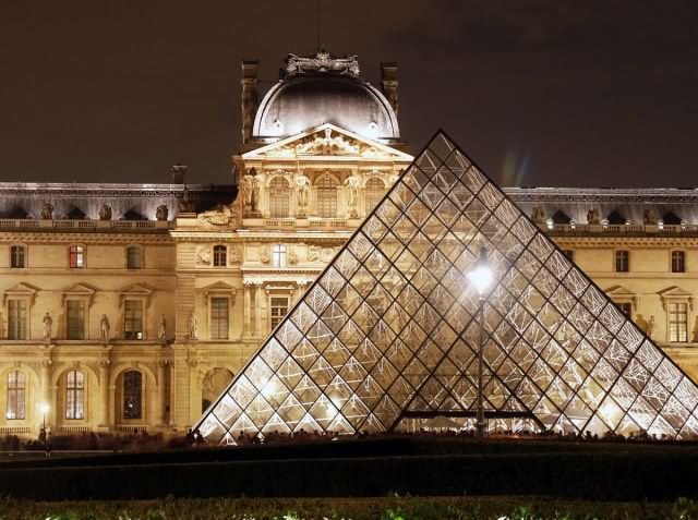 Front View Of Louvre Museum And Glass Pyramid At Night