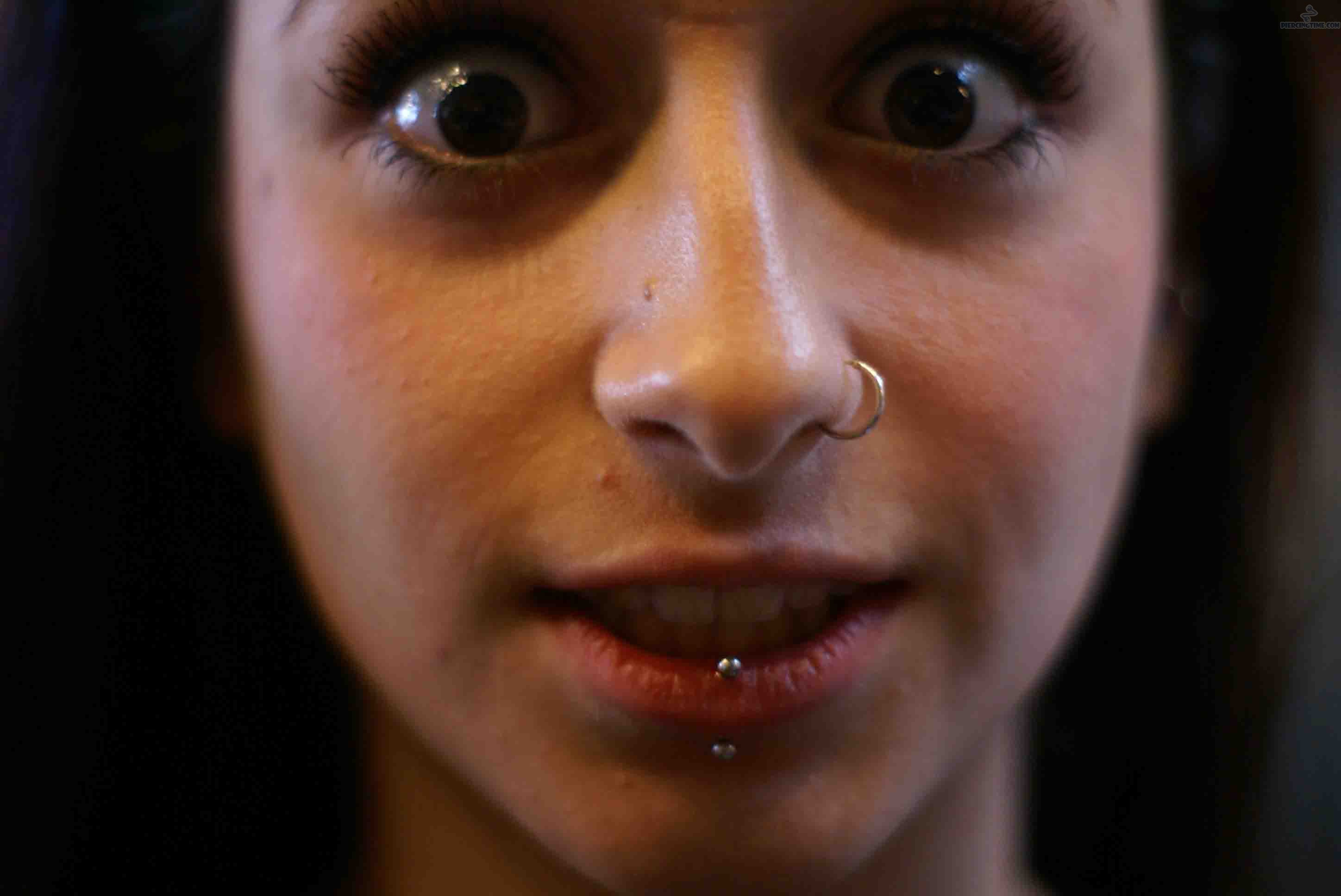 Girl With Left Nostril And Silver Barbell Center Labret Piercing