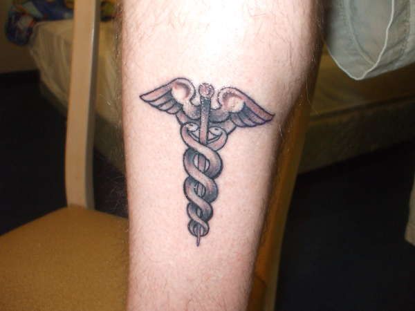 Grey Ink Medical Symbol Tattoo Design For Leg