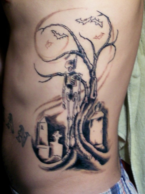 Halloween Skeleton Hanging On Tree Tattoo Design For Side Rib