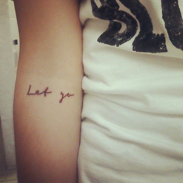 Let Go Lettering Tattoo On Inside Elbow