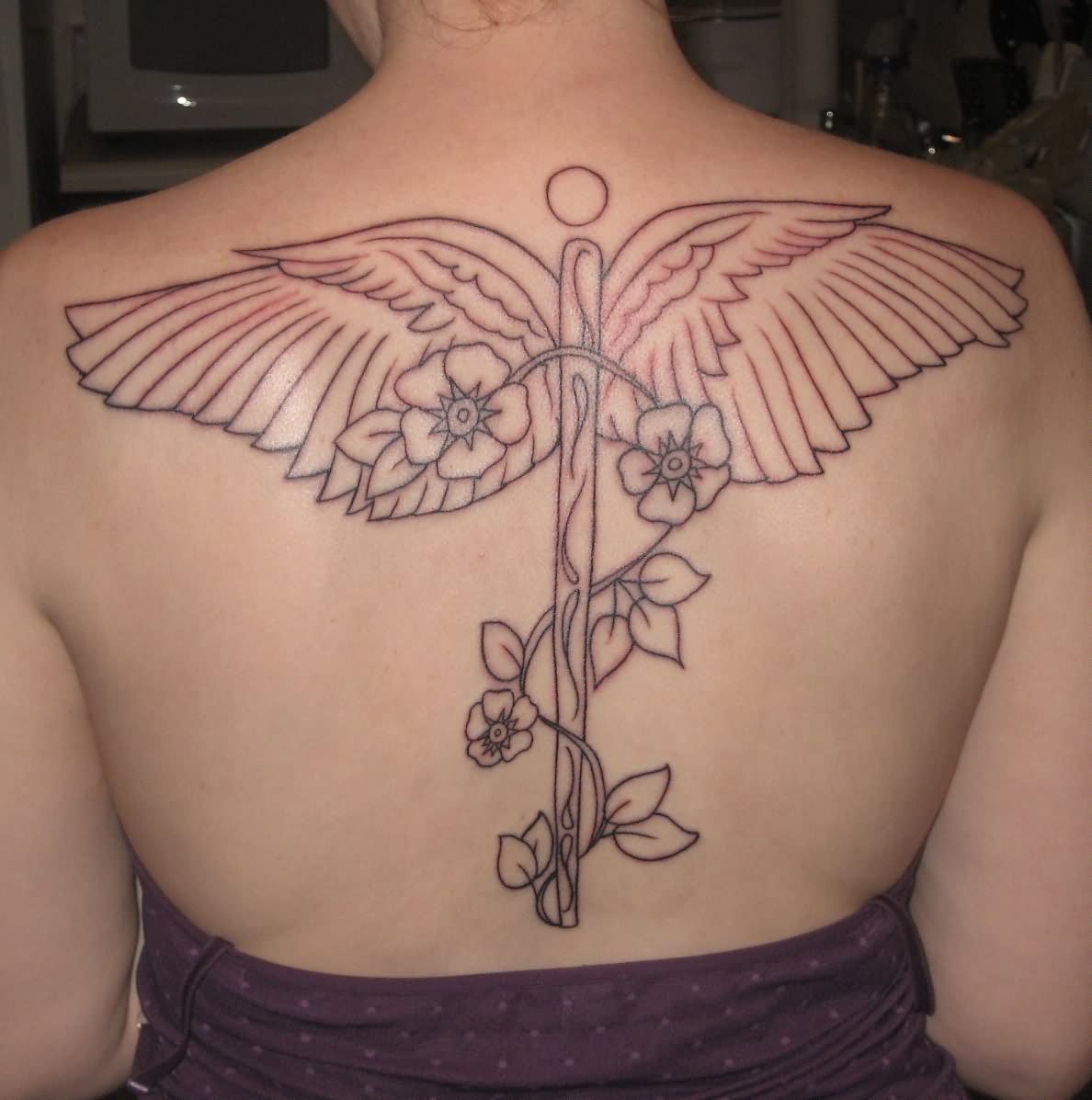 Medical Symbol With Flowers Tattoo On Upper Back
