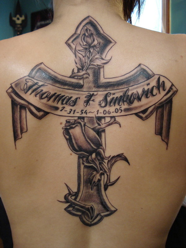 Memorial Black Ink Cross With Banner And Flower Tattoo On Upper back