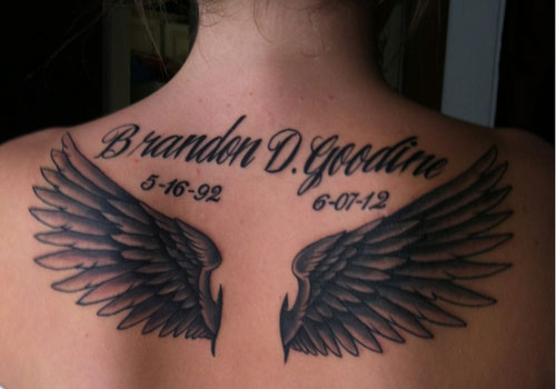 Memorial Black Ink Wings Tattoo On Upper Back