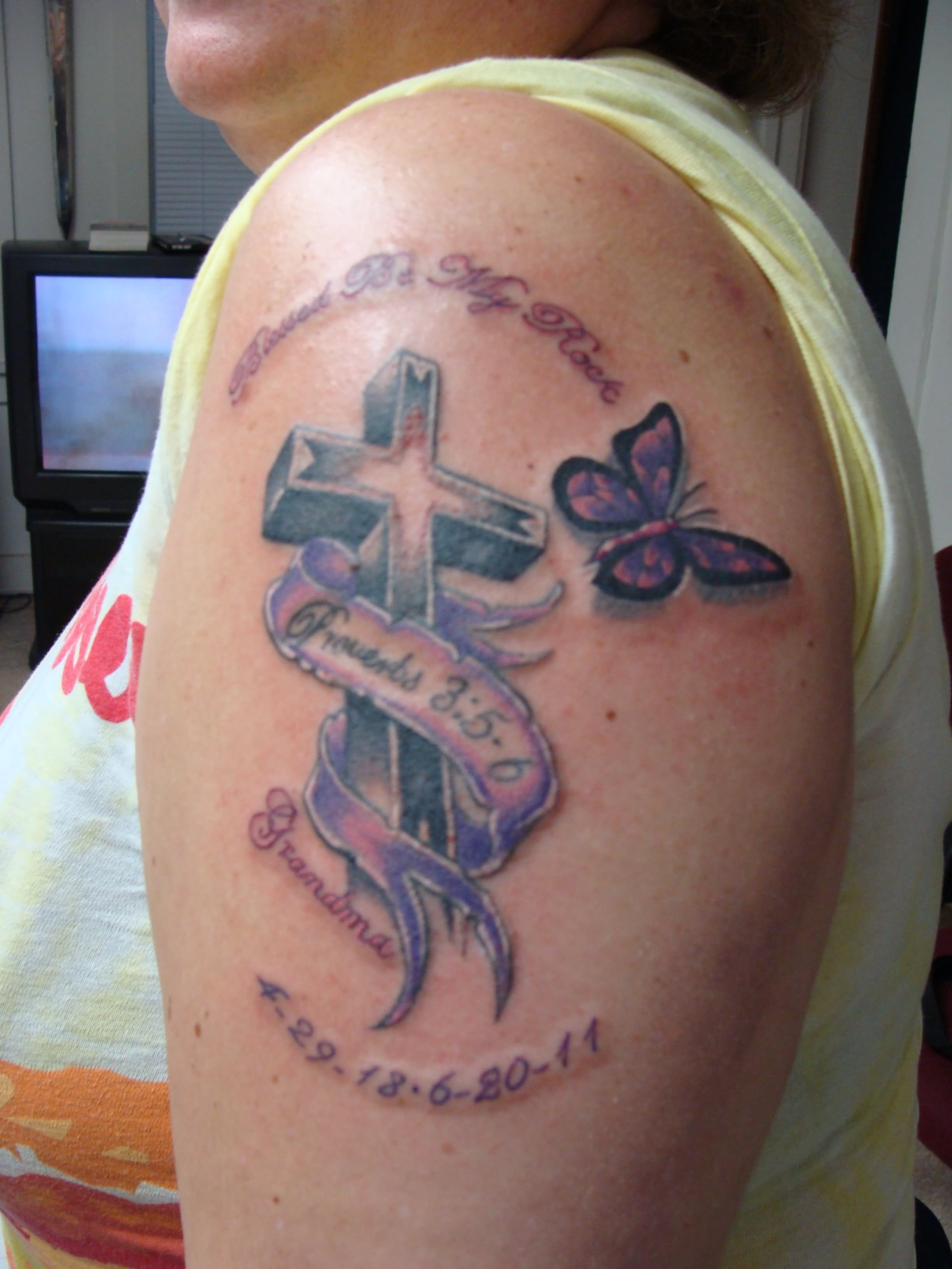 Memorial Cross With Banner And Butterfly Tattoo On Left Shoulder For Grandma