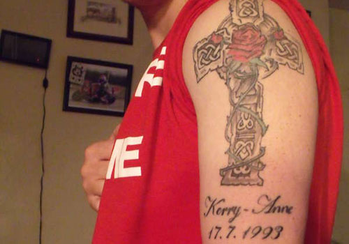 Memorial Cross With Rose Tattoo On Left Shoulder For Sister