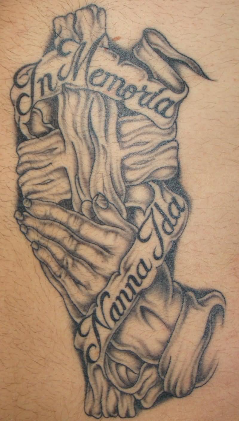 Memorial Grey Ink Wooden Cross And Praying Hand With Banner Tattoo Design