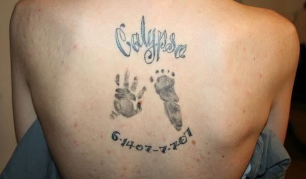 Memorial Hand And Foot Print Tattoo On Upper Back