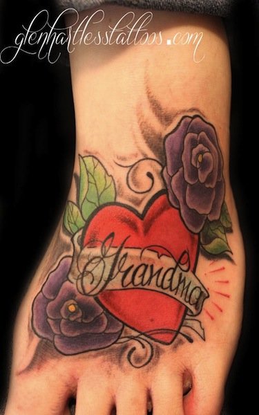 Memorial Heart With Grandma Banner And Flowers Tattoo On Foot