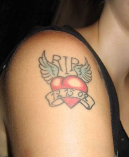 Memorial Heart With Wings And Banner Tattoo On Shoulder