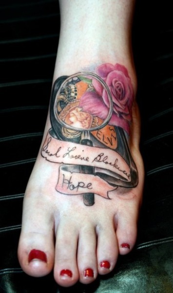 Memorial Rose With Banner Tattoo On Girl Foot For Sister