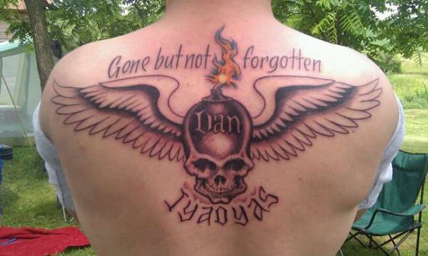 Memorial Skull With Wings Tattoo On Upper Back For Brother