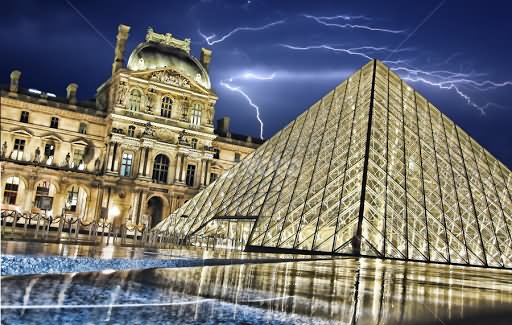 Night View Of Louvre Museum And Glass Pyramid With Thunderstorm