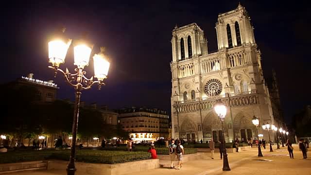Notre Dame de Paris At Night With Lighting Lamps