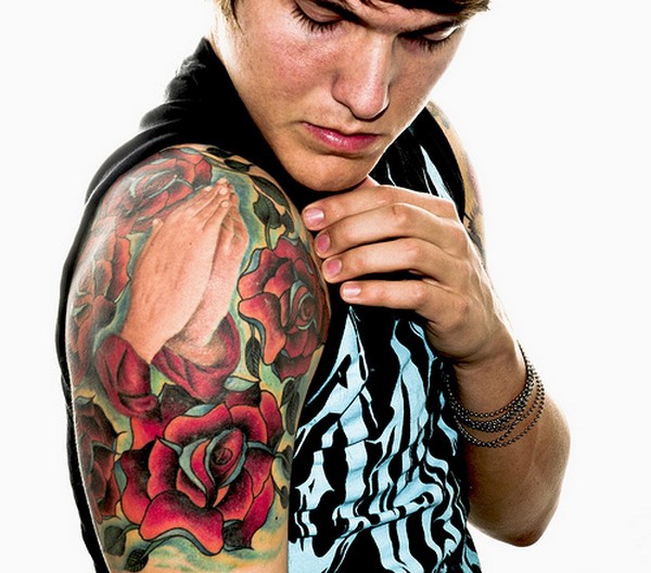 Red Floral With Praying Hands Tattoo On Man Right Shoulder