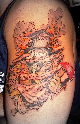 Ripped Skin Firefighter Tattoo On Left Shoulder