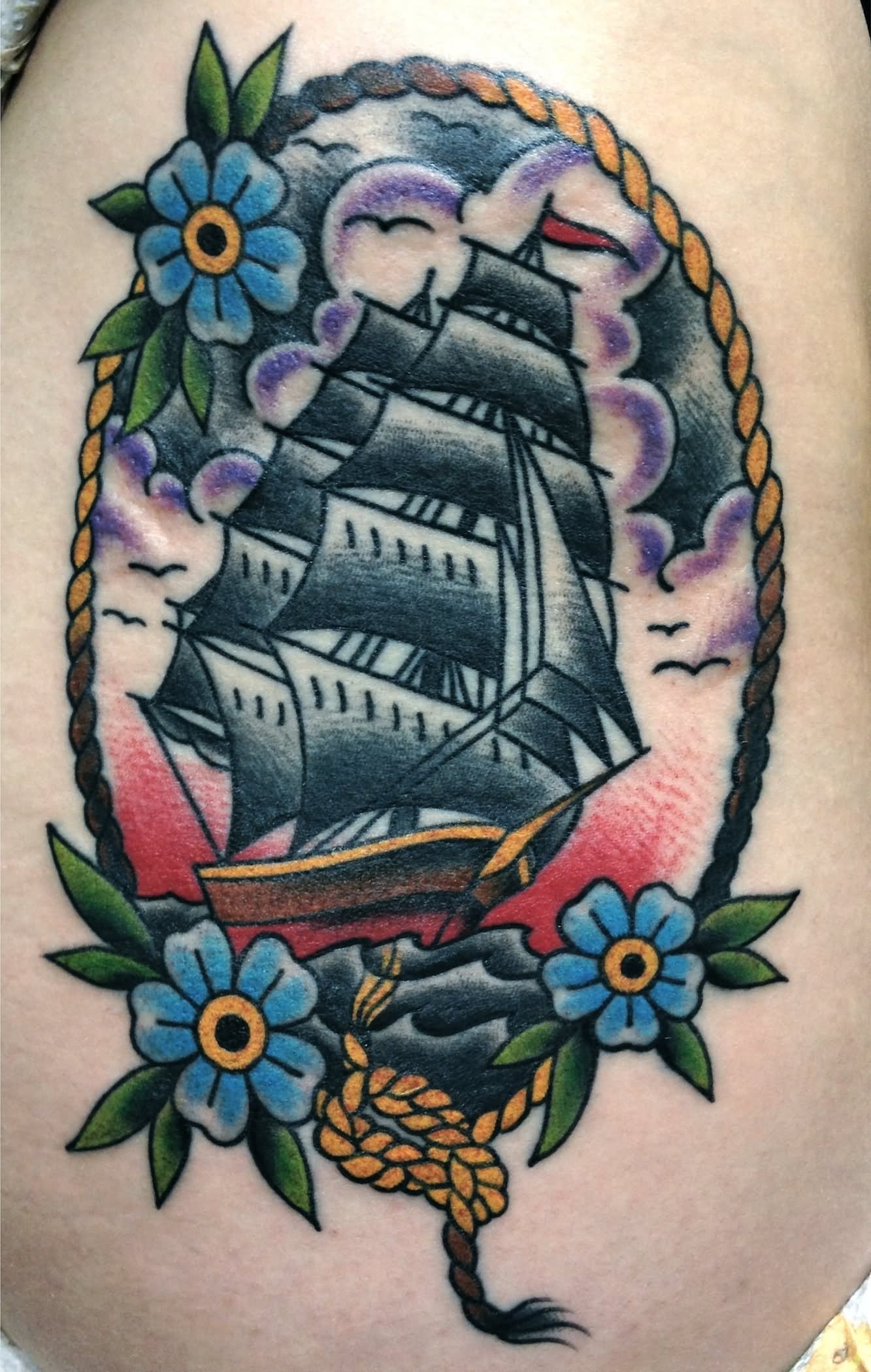 Sailor Ship In Rope Frame With Flowers Tattoo Design