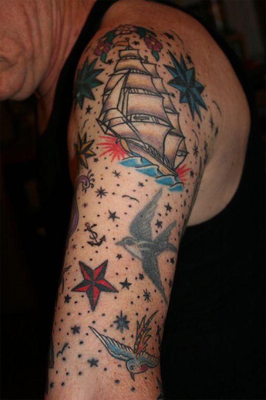 Sailor Ship With Flower And Nautical Star Tattoo On Man Left Half Sleeve