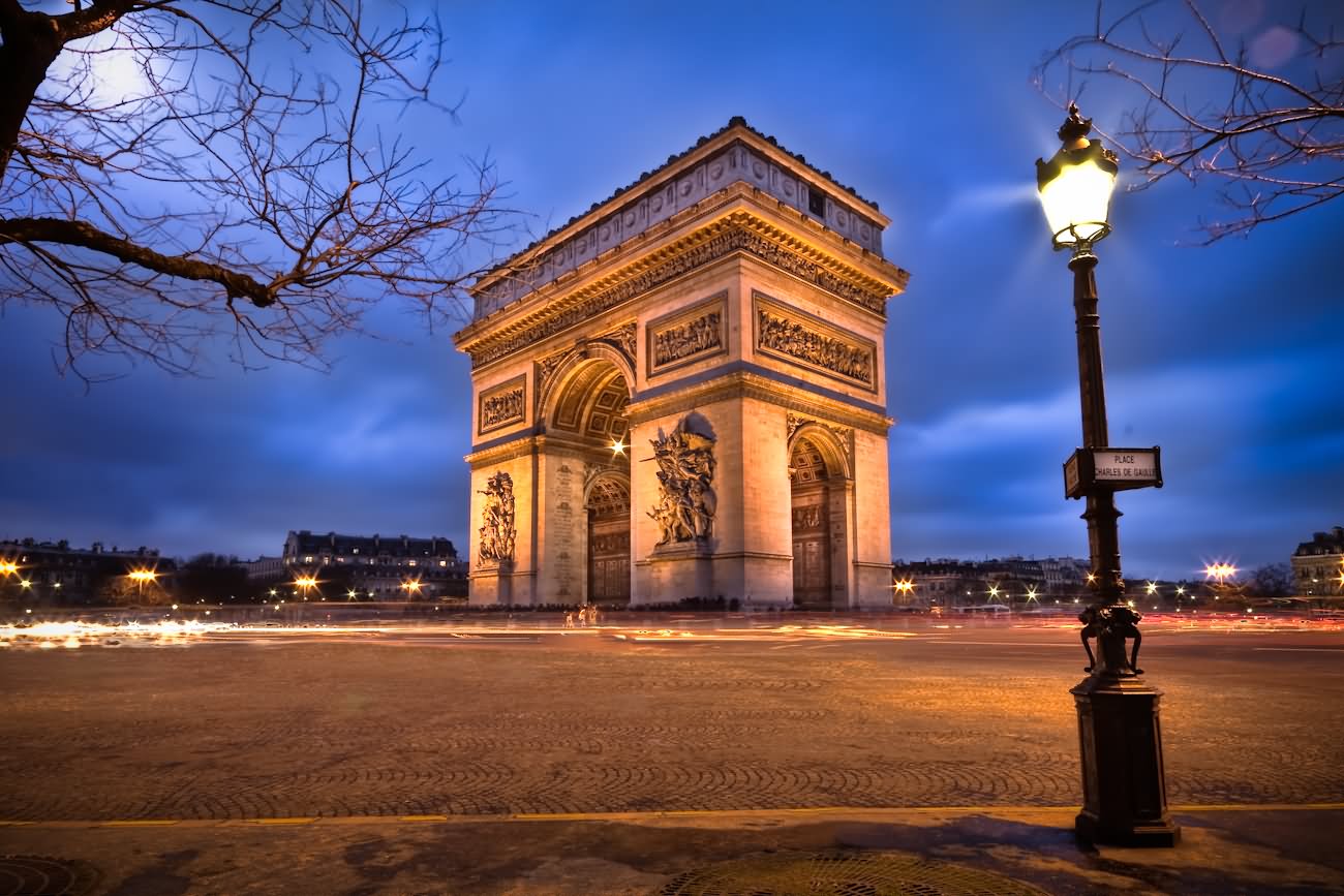 Side Night View Of Arc de Triomphe With Light Lamp