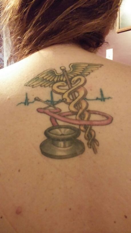 Stethoscope With Medical Symbol Tattoo On Upper Back