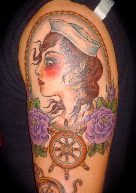 Traditional Sailor Girl Face In Frame With Wheel Tattoo Design For Half Sleeve