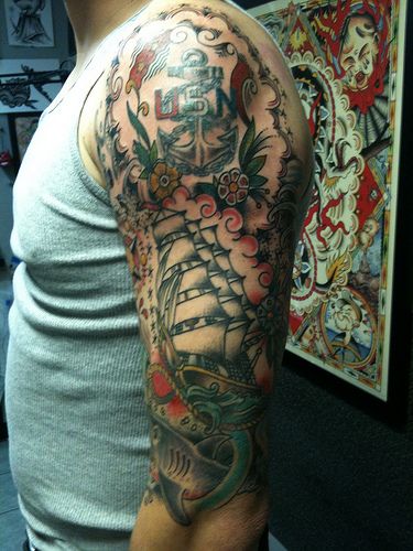 Traditional Sailor Ship With Anchor And Flowers Tattoo On Man Left Half Sleeve