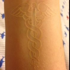 White Ink Medical Symbol Tattoo Design For Wrist