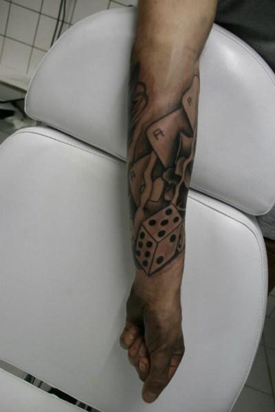 Black And Grey Gambling Tattoo On Left Forearm