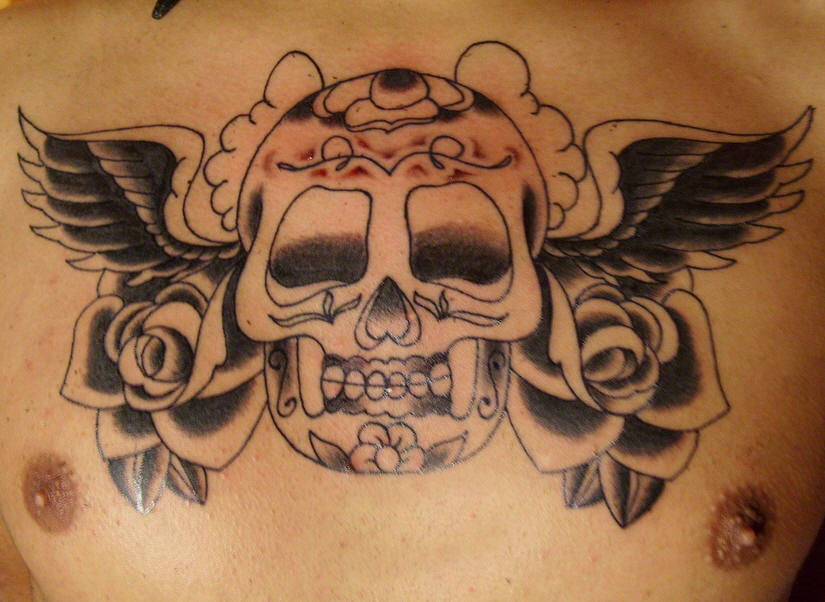 Black Roses And Winged Skull Mexican Tattoo On Chest