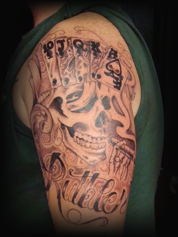 Grey Ink Skull And Playing Cards Gambling Tattoo On Left Shoulder