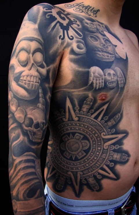 Realistic Grey Ink Tribal Mexican Tattoo On Sleeve And Side Rib