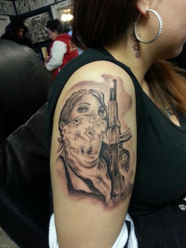 Amazing Gangster Gun In Girl Hand Tattoo On Girl Right Shoulder