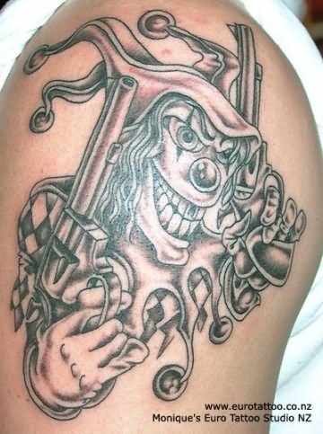 Black Ink Gun In Gangster Clown Tattoo On Shoulder