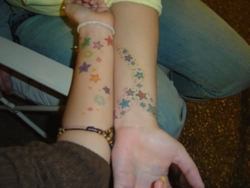 Colored Stars Friendship Tattoos On Forearm