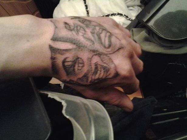 Two Gangster Mask Tattoo On Hand