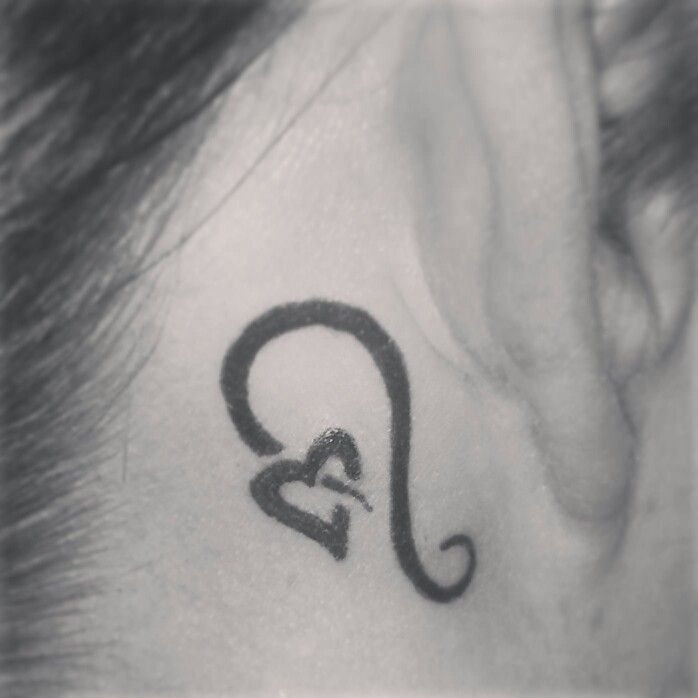 Amazing Black Leo Heart Symbol Tattoo On Girl Behind The Ear