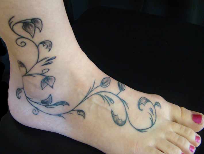 Black And Grey Leaves Vine Tattoo On Girl Foot