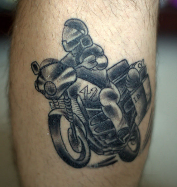 Black And Grey Motorcycle Tattoo On Leg