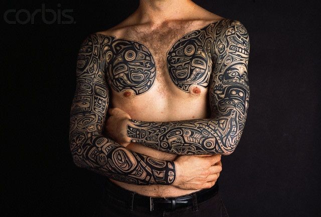 Black Hawaiian Design Tattoo On Man Both Full Sleeve And Chest