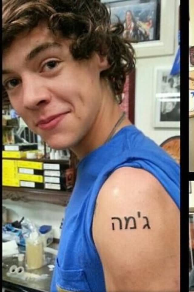 Black Hebrew Lettering Tattoo On Man Left Shoulder