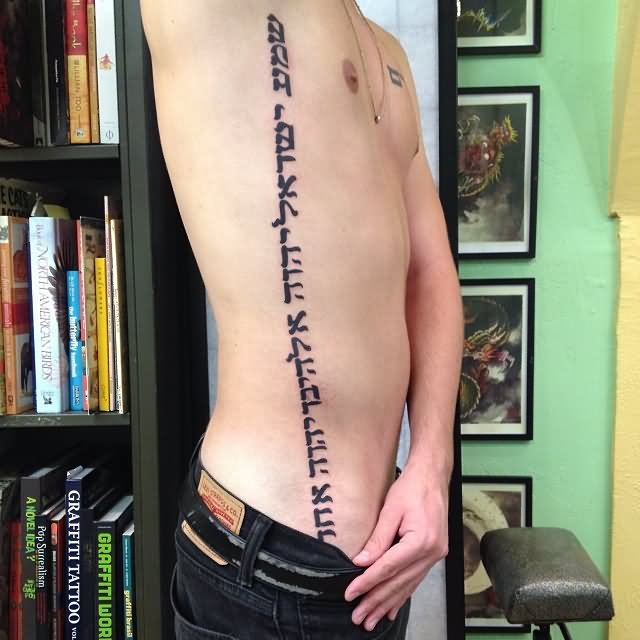 Black Hebrew Lettering Tattoo On Man Right Side Rib By Steven