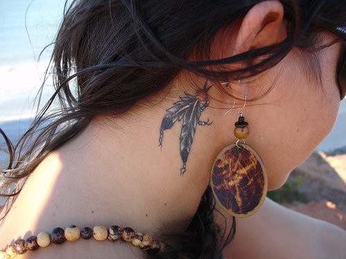 Black Hippie Feathers Tattoo On Girl Behind The Ear