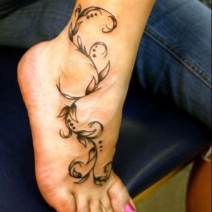 Black Ink Leaves Vine Tattoo On Girl Foot