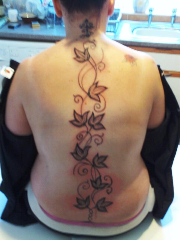 Black Ink Leaves Vine Tattoo On Man Full Back