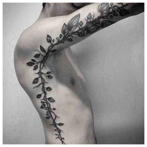 Black Ink Leaves Vine Tattoo On Man Right Side Rib And Sleeve