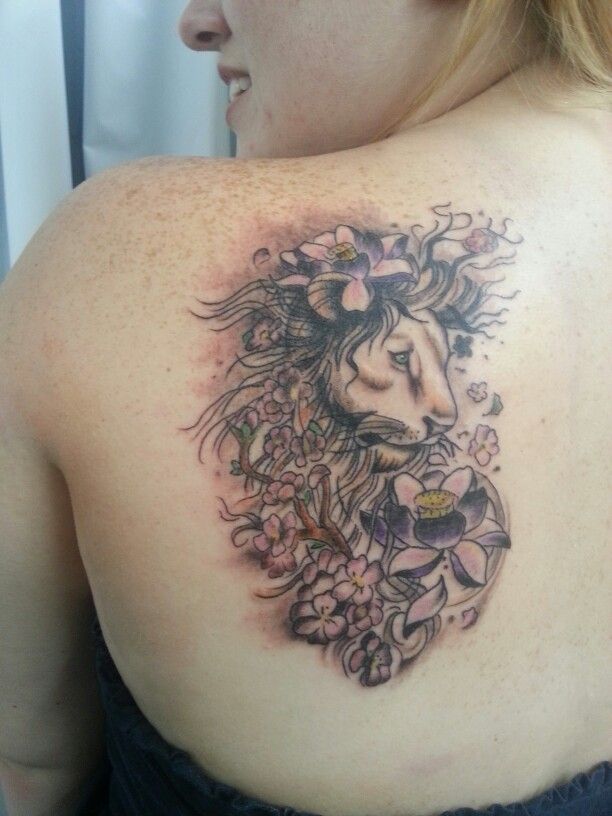 Black Ink Leo With Flowers Tattoo On Girl Left Back Shoulder
