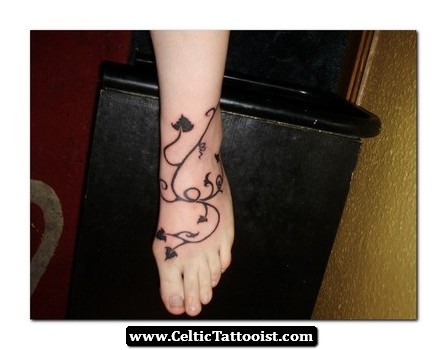 Black Leaves Vine Tattoo On Man Foot