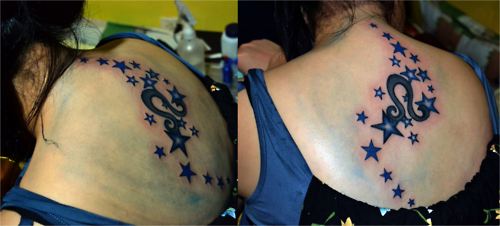 Black Leo Symbol With Stars Tattoo On Girl Upper Back